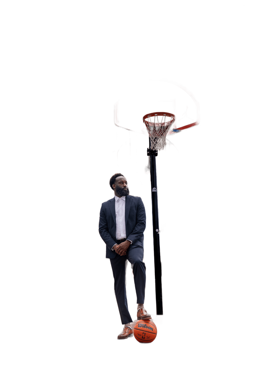 Ronald Platt, sports agent, leaning against a basketball hoop